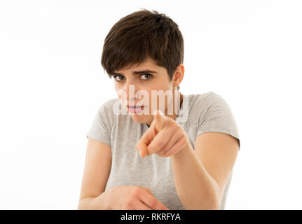 Close up portrait of scared and shocked young woman pointing at something surprising and scary. Looking with fear in her eyes. People and Human expres Stock Photo