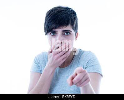 Close up portrait of scared and shocked young woman pointing at something surprising and scary. Looking with fear in her eyes. People and Human expres Stock Photo