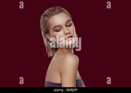 Slim model showing her open shoulders while posing for magazine Stock Photo