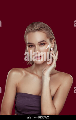 Photo model wearing open shoulder top promoting cosmetics Stock Photo