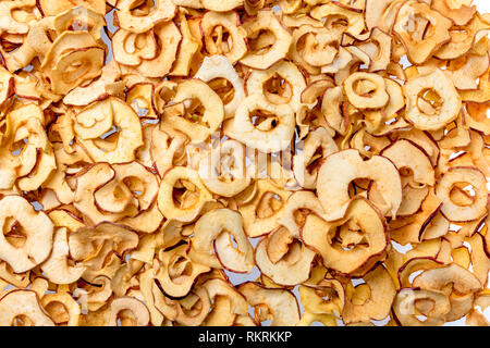 many dried apple pieces evenly distributed as a background Stock Photo