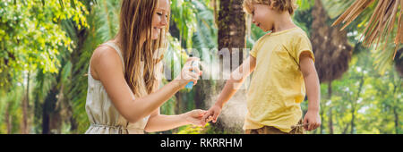 Mom and son use mosquito spray.Spraying insect repellent on skin outdoor BANNER, long format Stock Photo