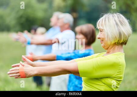 Active seniors in rehab are exercising with the stretch band in physiotherapy Stock Photo