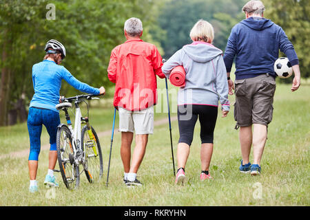 Senior group is doing sport or wellness together in the summer in the park Stock Photo