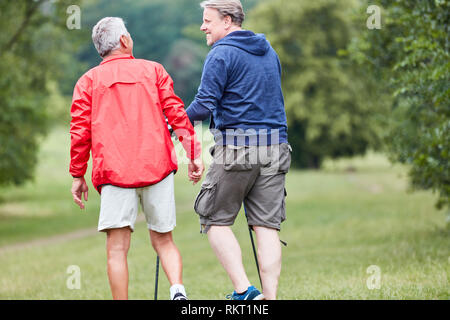 Two seniors together while hiking in nature on active vacation Stock Photo
