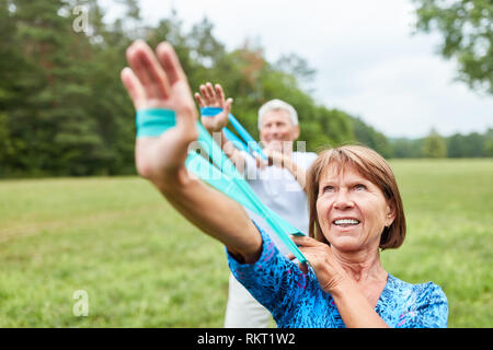 Senior couple doing together with physiotherapy with the stretch band Stock Photo