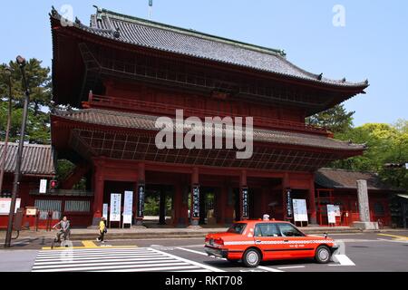 TOKYO - MAY 10: Taxi cab rides past a temple on May 10, 2012 in Tokyo, Japan. Tokyo has almost 60,000 taxi cabs, almost 5 times the number of New York Stock Photo