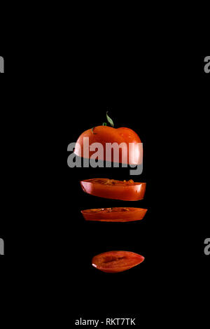 Creative concept with flying vegetables on an black background. Levity vegetable with water drops Stock Photo