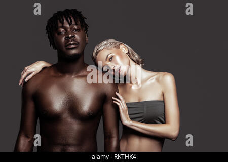 Couple of international models feeling busy while posing together Stock Photo