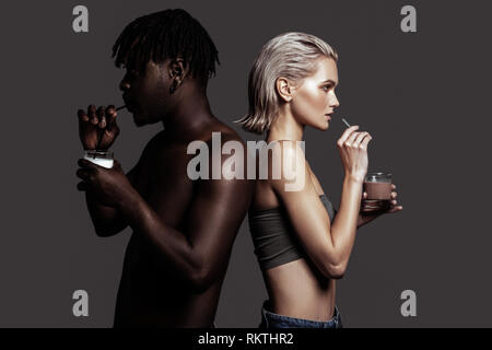 Models having different colors of skin sipping some drinks Stock Photo