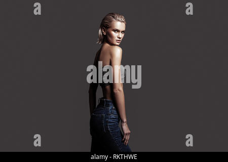 Professional blonde-haired model posing for her photographer Stock Photo
