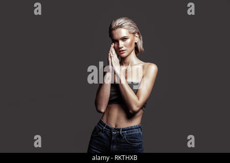 Slim woman with nice abs and body posing professionally Stock Photo