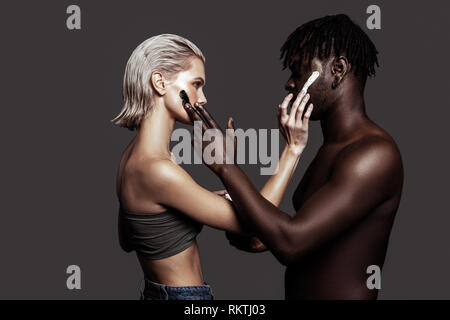 Two models with different skin colors promoting cosmetics Stock Photo