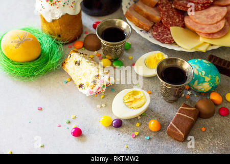 Easter meal Breakfast. Easter cake, painted eggs, red wine (Cahors) and delicious delicatessen on table. Copy space. Stock Photo