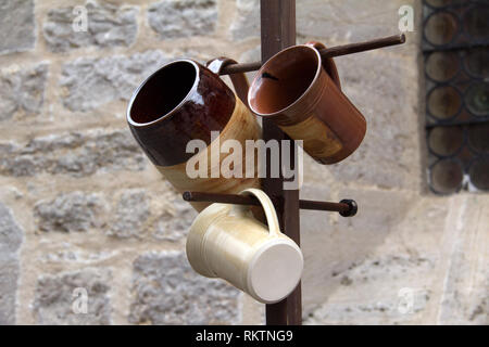 Ceramic mugs / Ceramic ware hanging on the hanger Stock Photo