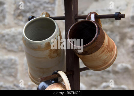 Ceramic mugs / Ceramic ware hanging on the hanger Stock Photo
