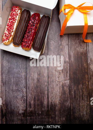 eclairs in a white box, delivery of eclairs, glazed eclairs, photos of eclairs close-up Stock Photo