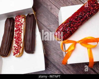 eclairs in a white box, delivery of eclairs, glazed eclairs, photos of eclairs close-up Stock Photo
