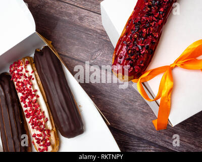 eclairs in a white box, delivery of eclairs, glazed eclairs, photos of eclairs close-up Stock Photo