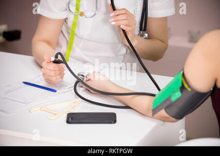 cosmetology beauty clinic. doctor checking patient's blood pressure, close-up of the patient's hand Stock Photo