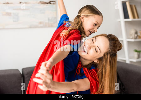 Smiling mother and cute kid playing at home Stock Photo