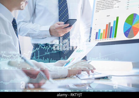 Businessmen or analysts discuss on business performance, investment risk analysis and return on investment, ROI, in the office. Stock Photo