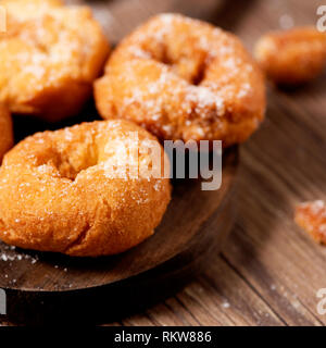 closeup of a pile of homemade rosquillas, spanish donuts typically eaten in Easter, on a rustic wooden table Stock Photo