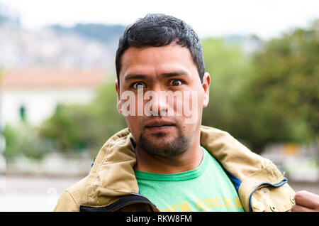 Shot in the head of a dark-skinned young man, surprised, with protruding eyes, with an expression of amazement, expressing amazement and shock. Stock Photo