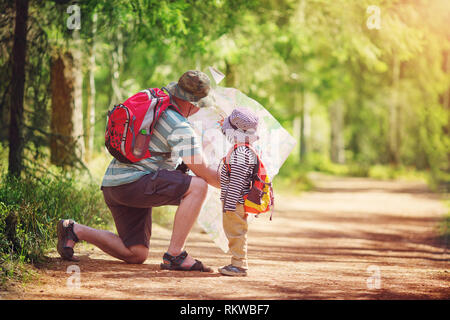 Father and boy going camping with tent in nature Stock Photo