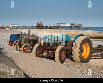 Fishermen's tractors on the beach at sunny Cromer in Norfolk. Stock Photo
