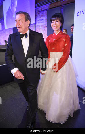 11 February 2019, Germany (German), Berlin: Former German Chancellor Gerhard Schröder (SPD) and his wife Soyeon Kim are taking part in the 'Cinema for Peace Gala' at the Westhafen Event & Convention Center. Photo: Britta Pedersen/dpa Stock Photo