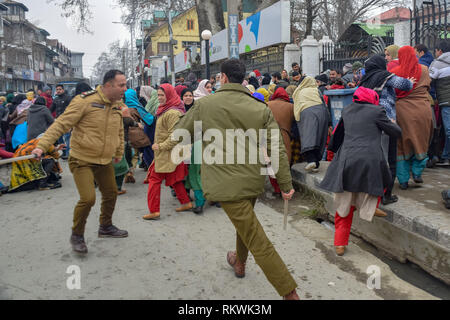 February 12, 2019 - Srinagar, Jammu & Kashmir - Members of Jammu and Kashmir police are seen charging batons over the NHM employees during protest in Srinagar.NHM (National Health Mission) employees on took out an anti-government protest march towards the Raj Bhavan in Srinagar. The employees who have been on a strike since the past thirty days are demanding regularization in a phased manner, equal pay for equal work and other social security benefits. Police used batons on the Protesters and many of them were detained during the protest. (Credit Image: © Idrees Abbas/SOPA Images via Z