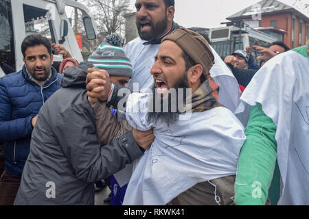 February 12, 2019 - Srinagar, Jammu & Kashmir - A member of Jammu and Kashmir police in civvies seen detaining a member of NHM employees during the Protest in Srinagar.NHM (National Health Mission) employees on took out an anti-government protest march towards the Raj Bhavan in Srinagar. The employees who have been on a strike since the past thirty days are demanding regularization in a phased manner, equal pay for equal work and other social security benefits. Police used batons on the Protesters and many of them were detained during the protest. (Credit Image: © Idrees Abbas/SOPA Ima