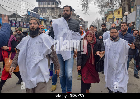 February 12, 2019 - Srinagar, Jammu & Kashmir - NHM employees are seen shouting anti government slogans during the protest in Srinagar.NHM (National Health Mission) employees on took out an anti-government protest march towards the Raj Bhavan in Srinagar. The employees who have been on a strike since the past thirty days are demanding regularization in a phased manner, equal pay for equal work and other social security benefits. Police used batons on the Protesters and many of them were detained during the protest. Credit: Idrees Abbas/SOPA Images/ZUMA Wire/Alamy Live News