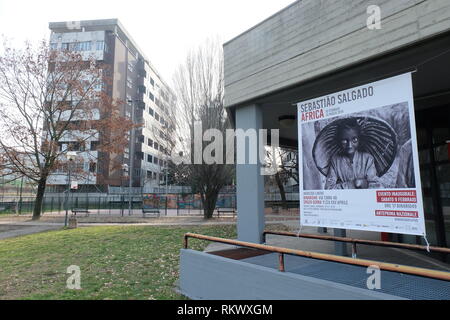 Reggio Emilia, Italy. 09th Feb, 2019. A poster refers to the photo exhibition with the works of Sebastião Salgado in 'Binario 49'. The Brazilian photographer 'donated' an exhibition to the infamous quarter in Italy in order to fight xenophobia. He lent 100 of his works to the project for the show 'Africa'. Credit: Alvise Armellini/dpa/Alamy Live News Stock Photo