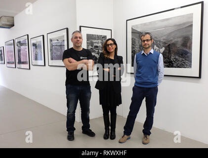 Reggio Emilia, Italy. 09th Feb, 2019. The directors of the project called 'Binario 49', Khadija Lamami, Claudio Melioli (l) and Alessandro Patroncini are in the photo exhibition they initiated with the works of Sebastião Salgado. The Brazilian photographer 'donated' an exhibition to the infamous quarter in Italy in order to fight xenophobia. He lent them 100 of his works for the show 'Africa'. Credit: Alvise Armellini/dpa/Alamy Live News Stock Photo