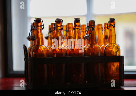 Empty beer bottles / Brown beer bottles in a crate Stock Photo