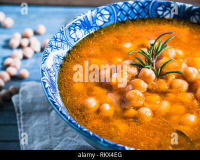 Chickpea soup, vegan, vegetarian. Italian traditional dish served in a bowl with bread and rosemary. Vegetarian and protein dish Stock Photo