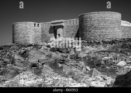 An Infrared monochrome image of Fort Houmet Herbe and causeway on an offshore island on the coast of Aldernney, Channel Islands. Stock Photo