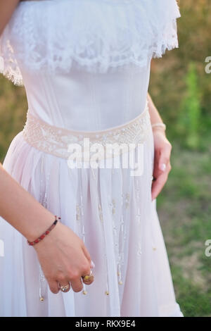 The bride is preparing for the wedding, the hands of the bride close-up. ceremony on the street. Stock Photo