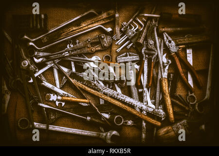 Different old kinds of tools and keys on jute bag Stock Photo