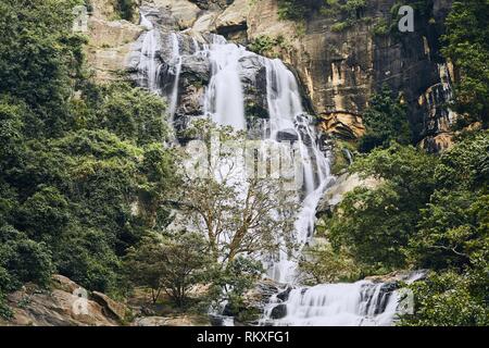 Waterfall in the middle of pure nature. Ravana Falls near town Ella is popular sightseeing attraction in Sri Lanka. Stock Photo