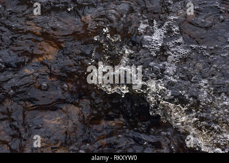 A raging stream of water in a swift stream Stock Photo - Alamy
