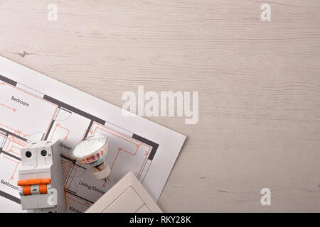 Equipment on white wooden table for electrical installation of housing close up. Horizontal composition. Top view. Stock Photo