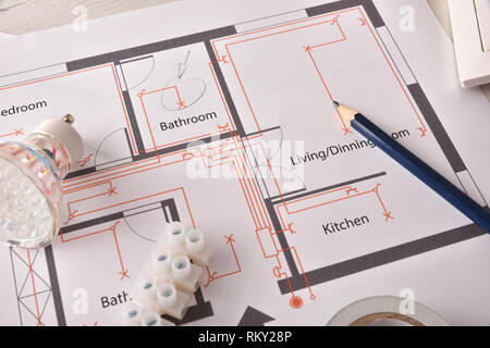 Equipment on white wooden table for electrical installation of housing close up. Horizontal composition. Elevated view. Stock Photo