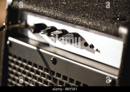 Close-up photo of guitar amplifier with cable audio jack. Musical instruments. Music equipment Stock Photo