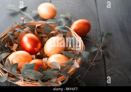 Easter eggs in the basket. Image toning. Living coral. Stock Photo