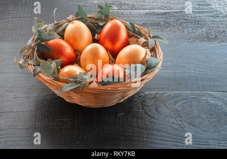 Easter eggs in the basket. Image toning. Easter eggs painted in color Living coral. Stock Photo