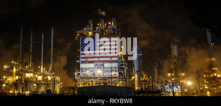 Panorama of large American flag displayed on the side of an oil refinery at night. Stock Photo