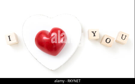 Red heart and wooden cubes with I and You, on white background. I love you concept. Stock Photo